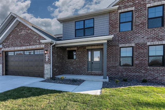 view of front of home featuring a garage and a front lawn