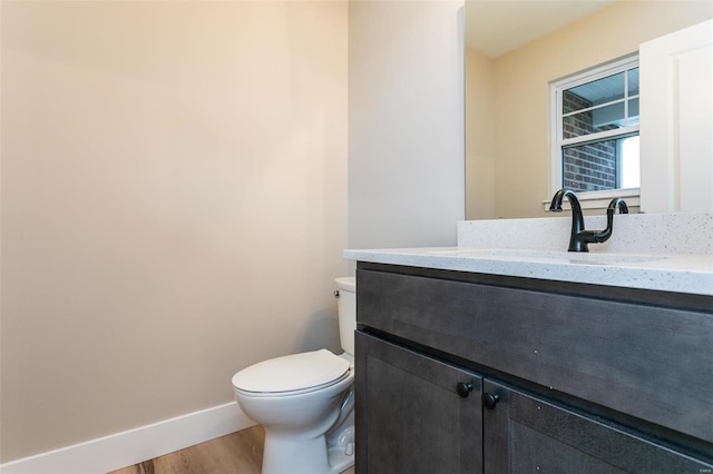 bathroom with vanity, wood-type flooring, and toilet