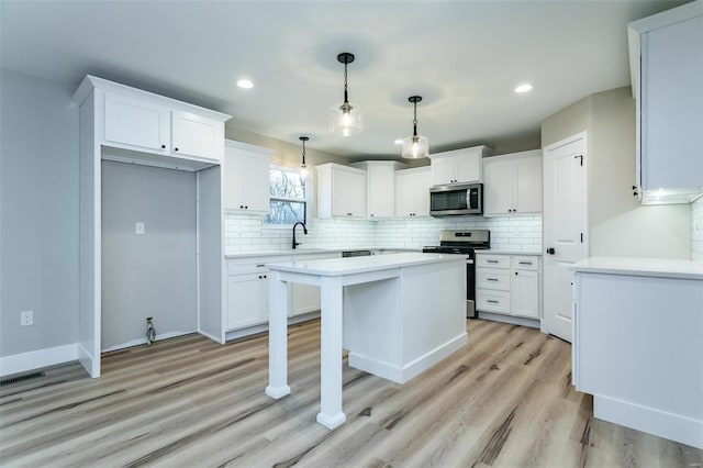 kitchen featuring sink, white cabinets, and appliances with stainless steel finishes