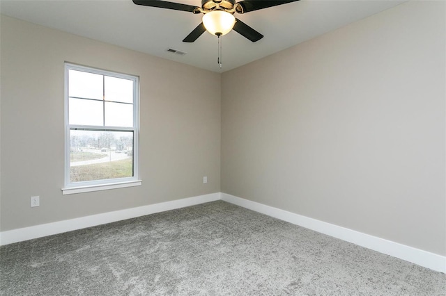 carpeted spare room with ceiling fan