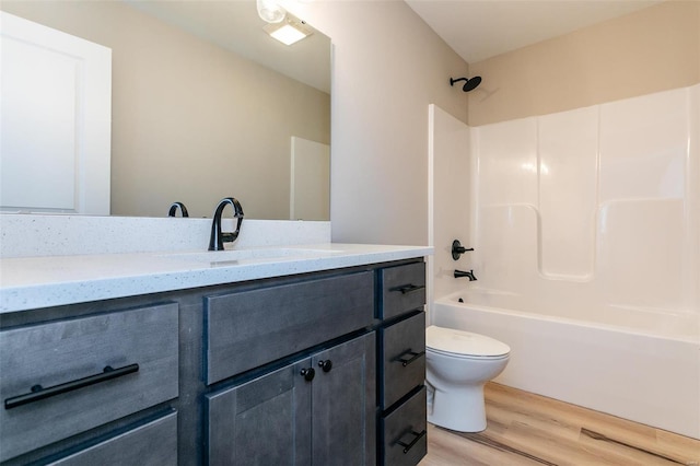 full bathroom featuring wood-type flooring, shower / bathing tub combination, vanity, and toilet