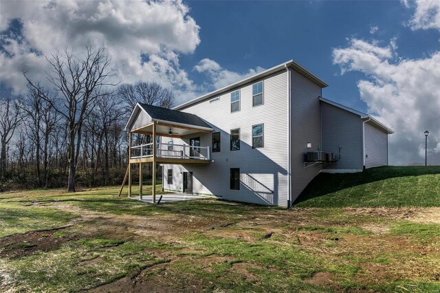 back of property featuring a yard, a patio, and ceiling fan