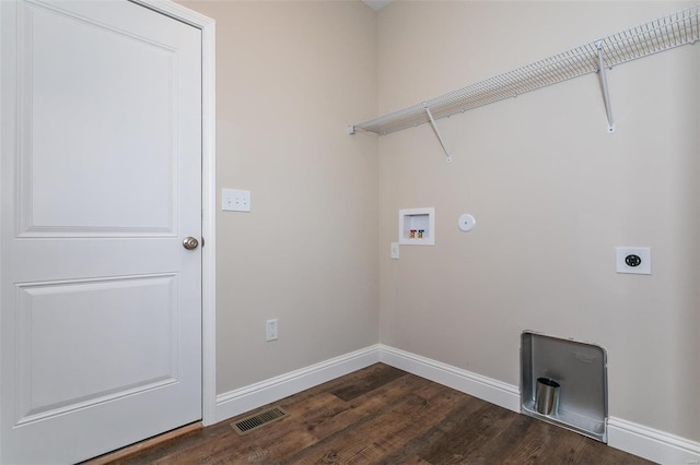 clothes washing area featuring electric dryer hookup, dark hardwood / wood-style floors, and washer hookup