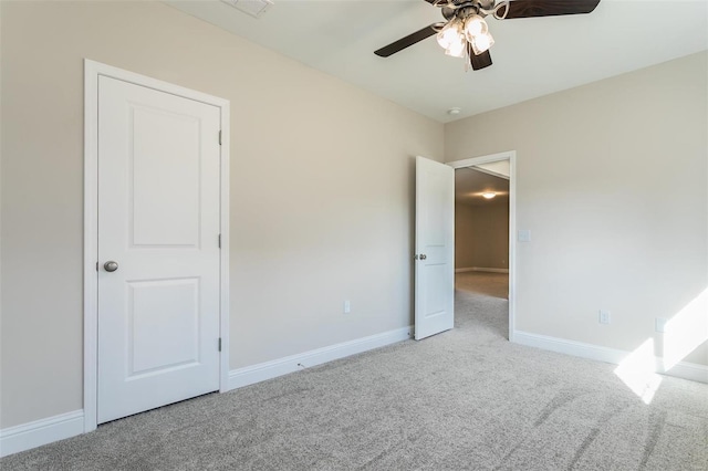 unfurnished bedroom with light colored carpet and ceiling fan