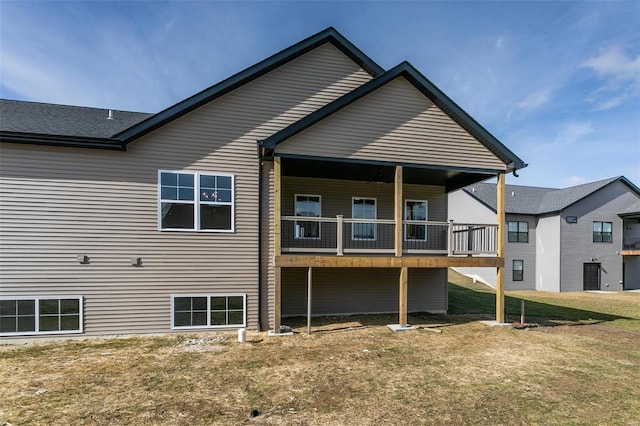 rear view of property with a lawn