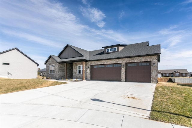 view of front of property featuring a garage and a front lawn