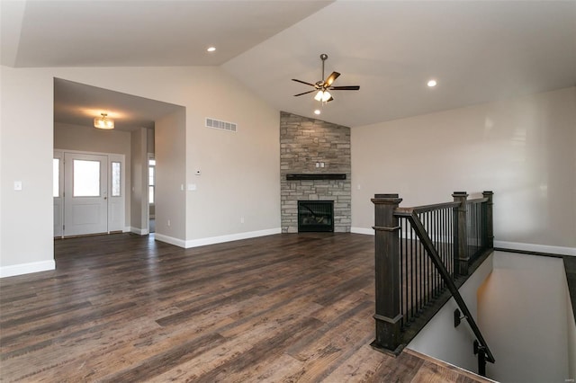 living room with ceiling fan, lofted ceiling, dark wood-type flooring, and a fireplace