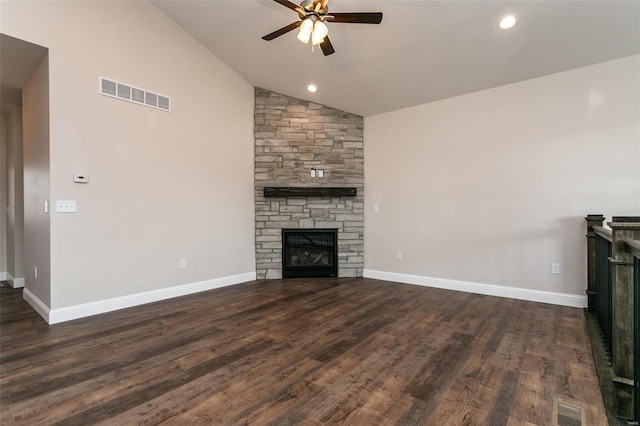 unfurnished living room featuring dark hardwood / wood-style floors, ceiling fan, a stone fireplace, and high vaulted ceiling