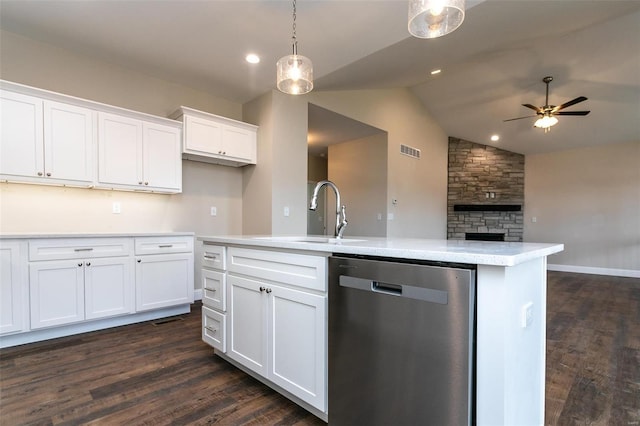 kitchen with sink, hanging light fixtures, a center island with sink, dishwasher, and white cabinets