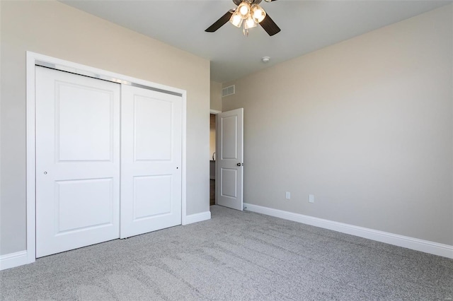 unfurnished bedroom with light carpet, a closet, and ceiling fan