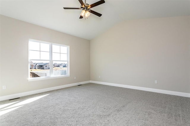 spare room with ceiling fan, lofted ceiling, and carpet floors