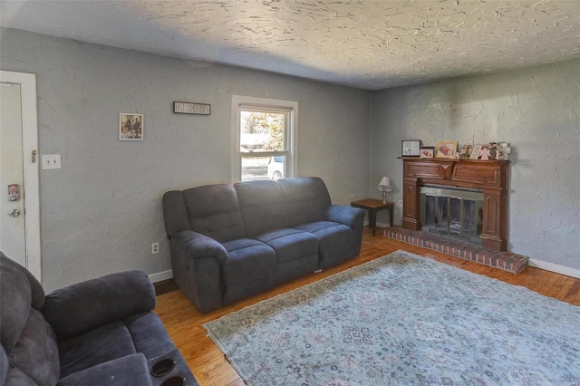 living room featuring hardwood / wood-style floors and a textured ceiling