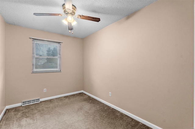 spare room with carpet, ceiling fan, and a textured ceiling