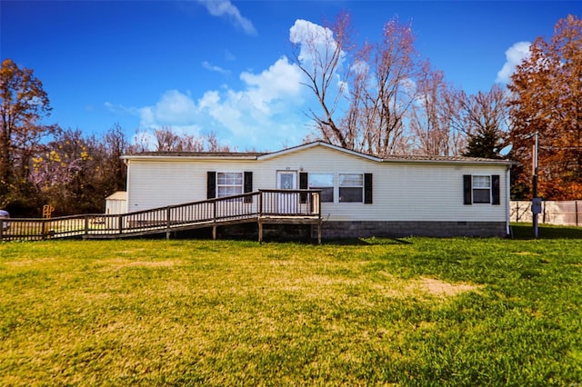 rear view of property with a deck and a yard