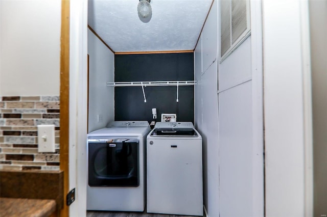 laundry area featuring separate washer and dryer and crown molding