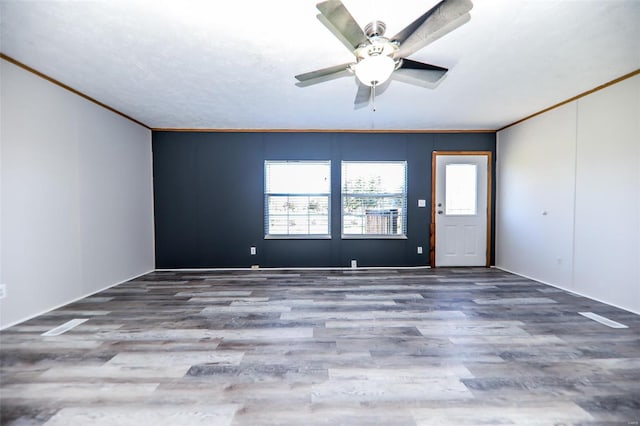 spare room featuring ceiling fan, ornamental molding, and hardwood / wood-style flooring