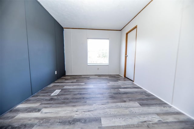 spare room with hardwood / wood-style flooring