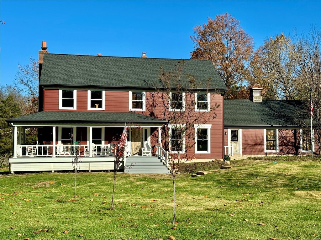 view of front of home featuring a front yard and a porch