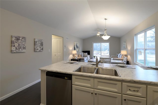 kitchen featuring stainless steel dishwasher, a healthy amount of sunlight, sink, and vaulted ceiling