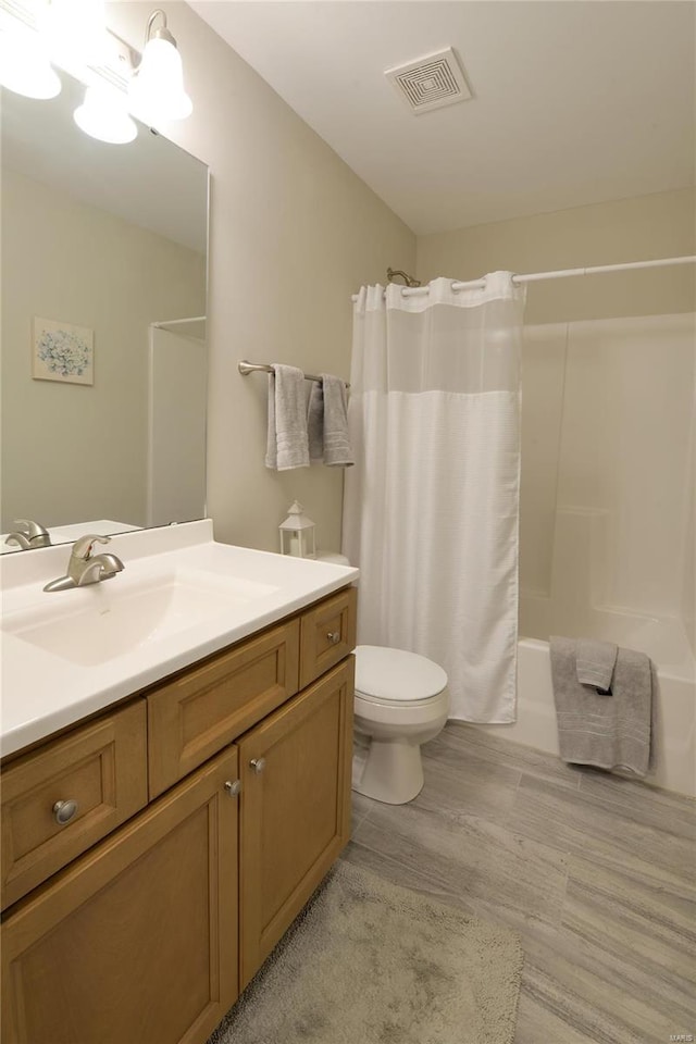 full bathroom with wood-type flooring, vanity, toilet, and shower / bathtub combination with curtain