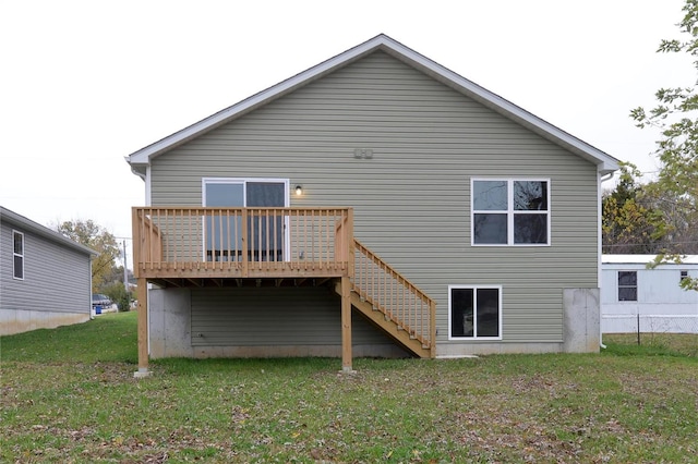 rear view of property with a yard and a wooden deck