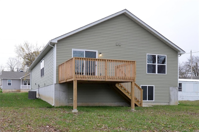 back of house with a yard, a wooden deck, and central air condition unit