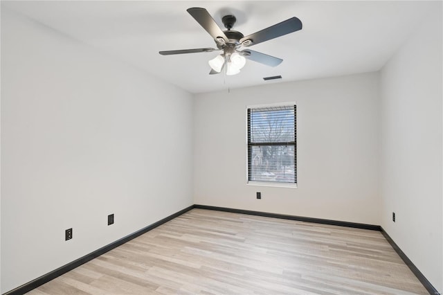 spare room with ceiling fan and light wood-type flooring