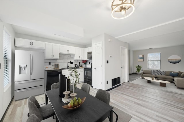 dining space featuring light hardwood / wood-style flooring and sink