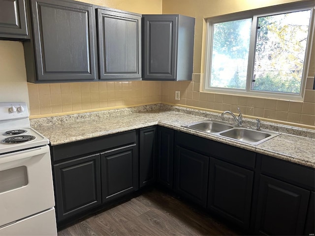 kitchen with white range with electric stovetop, decorative backsplash, sink, and dark wood-type flooring