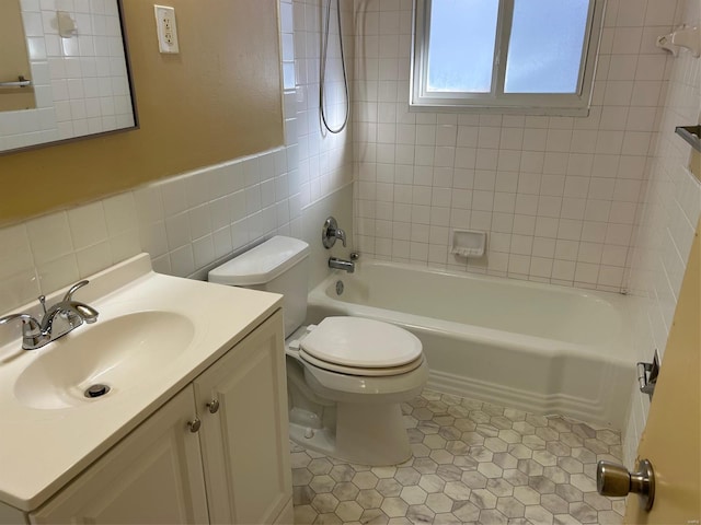 full bathroom with tile patterned flooring, toilet, vanity, tile walls, and tiled shower / bath