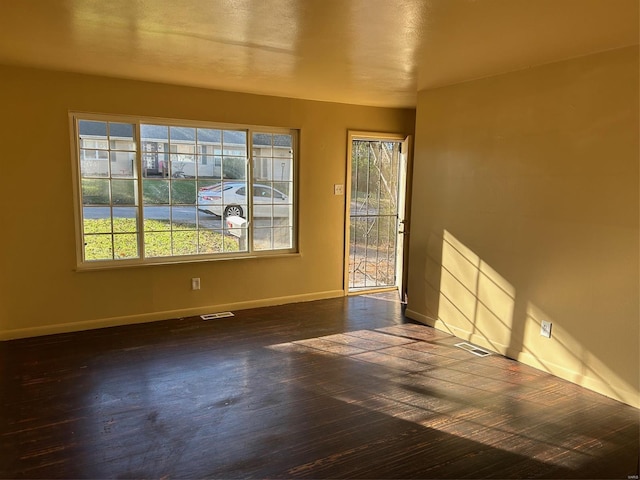 unfurnished room featuring dark wood-type flooring