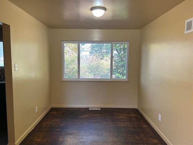 spare room featuring dark hardwood / wood-style floors