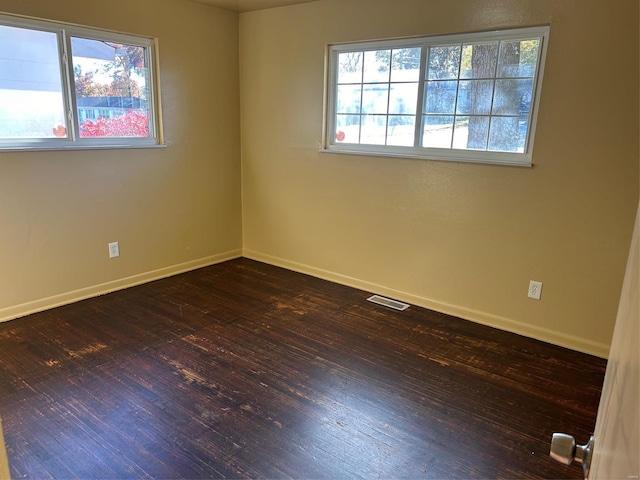 empty room with dark wood-type flooring