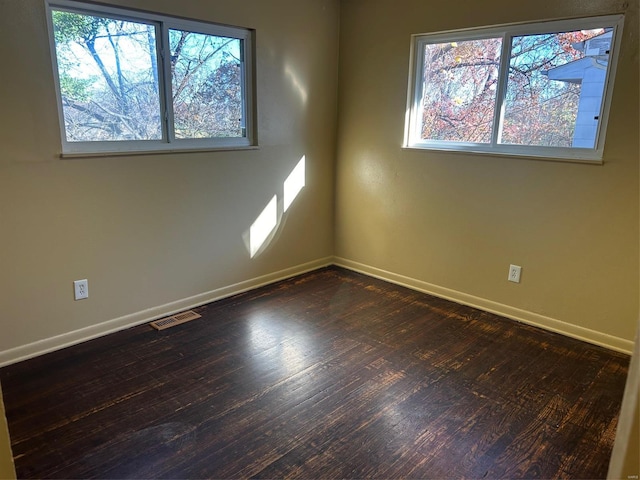 unfurnished room featuring dark hardwood / wood-style flooring