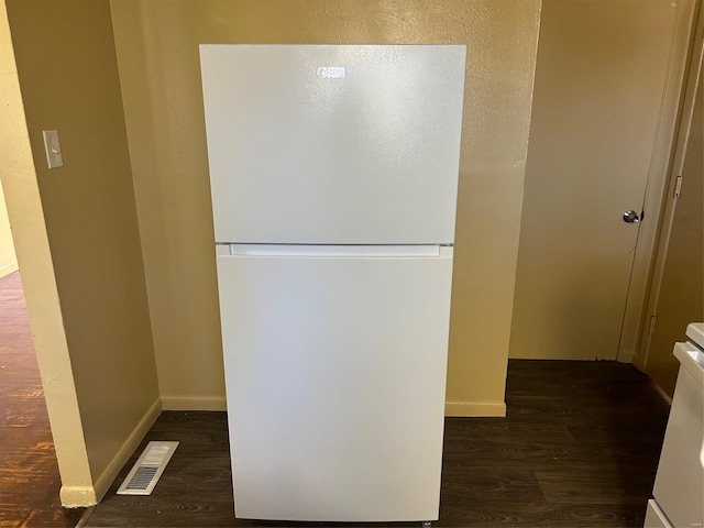 interior space featuring white refrigerator and dark hardwood / wood-style flooring