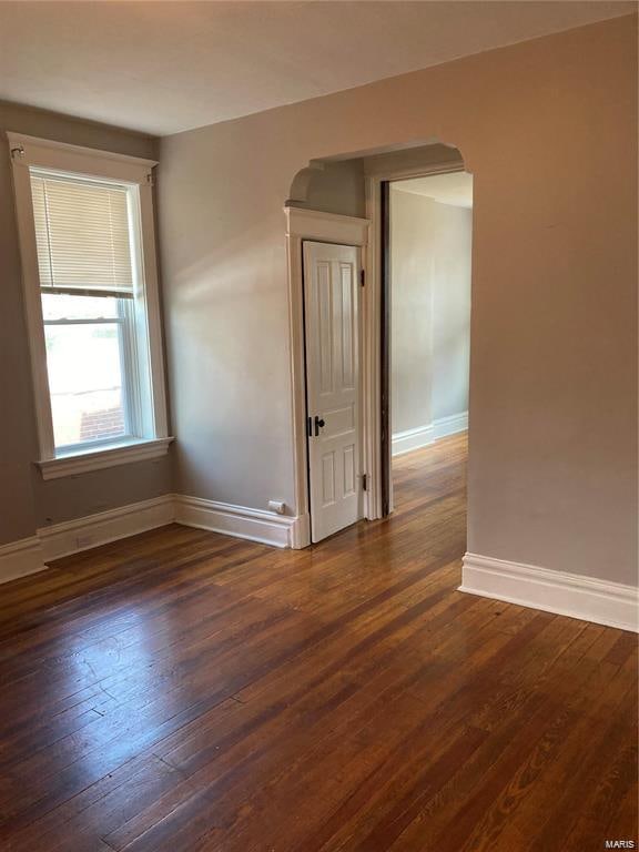 unfurnished room with dark hardwood / wood-style floors