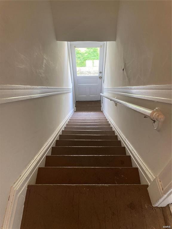 stairway with hardwood / wood-style flooring