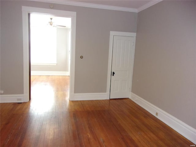 unfurnished room featuring hardwood / wood-style floors, ceiling fan, and crown molding