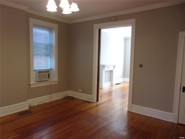 empty room featuring crown molding, cooling unit, wood-type flooring, and a notable chandelier