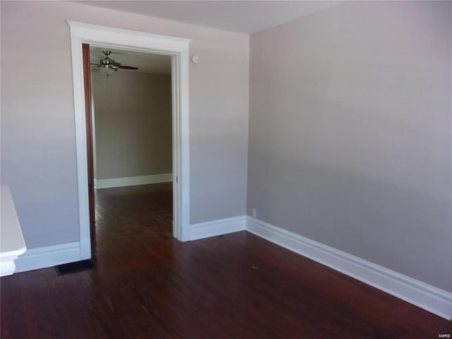 unfurnished room with ceiling fan and dark hardwood / wood-style flooring