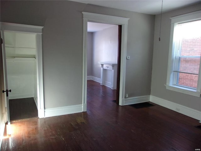 unfurnished room featuring dark wood-type flooring