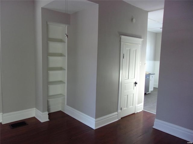 unfurnished room with dark wood-type flooring