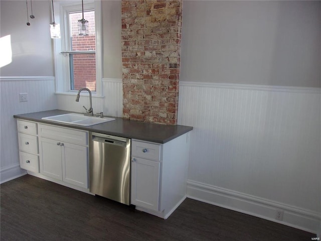 kitchen with stainless steel dishwasher, dark wood-type flooring, sink, decorative light fixtures, and white cabinets