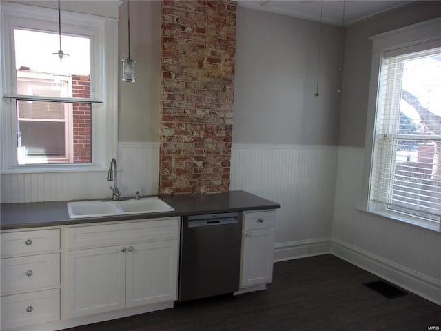 kitchen with dishwasher, white cabinets, sink, dark hardwood / wood-style floors, and decorative light fixtures