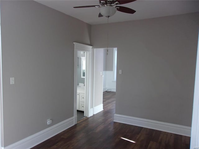 empty room with ceiling fan and dark wood-type flooring