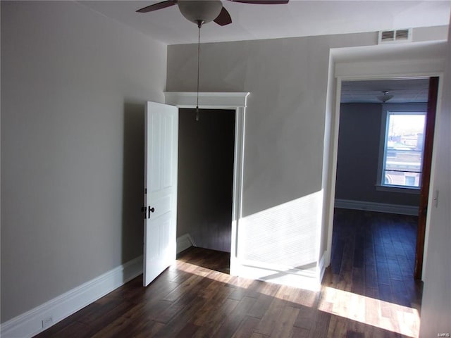 spare room with ceiling fan and dark wood-type flooring