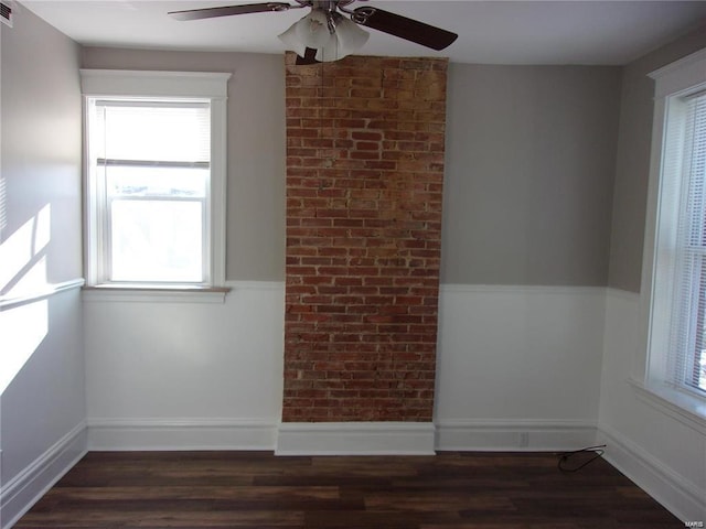 spare room featuring ceiling fan and dark wood-type flooring