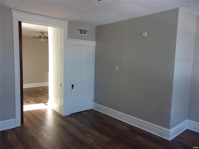 empty room with ceiling fan and dark wood-type flooring