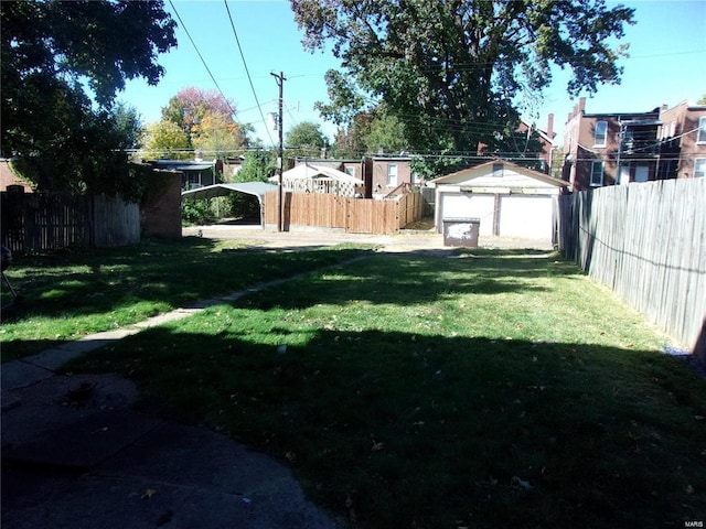 view of yard with a garage and an outdoor structure