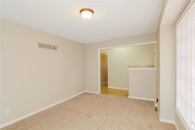 unfurnished room with light colored carpet